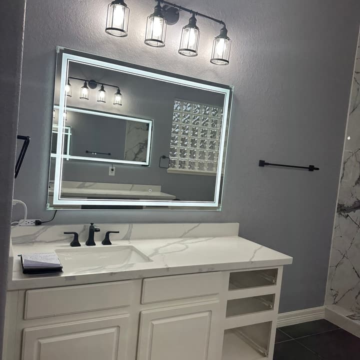Bathroom vanity with LED mirror, marble-look quartz countertop and matte-black fixtures