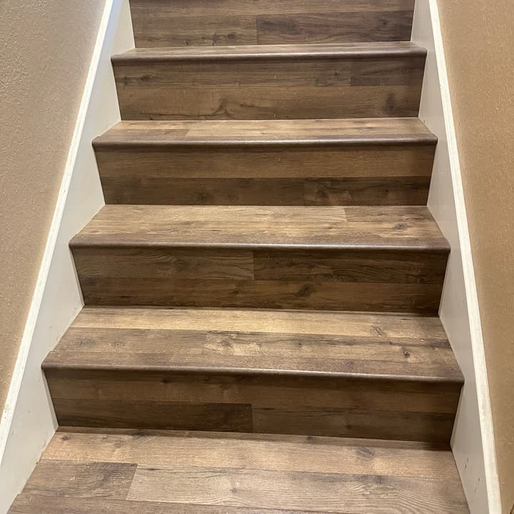 Staircase clad in wood-look plank flooring, treads and risers