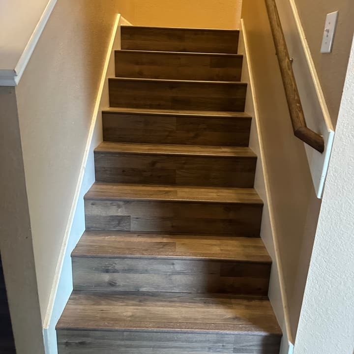 Remodeled staircase with wood-look plank treads seen from above