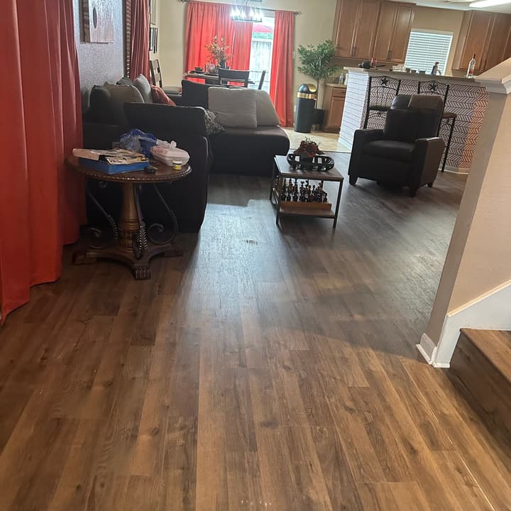 Living room with new wood-look plank flooring installed
